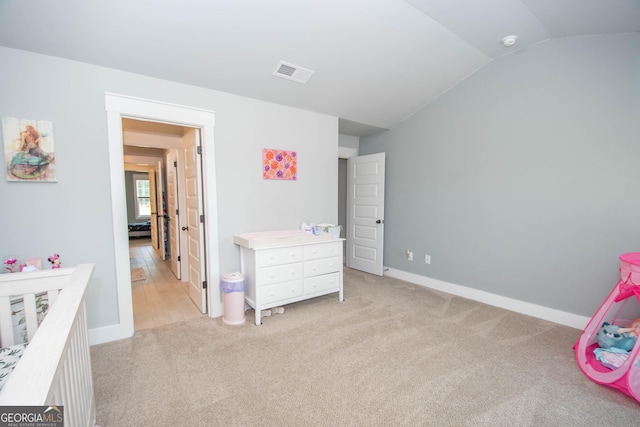 carpeted bedroom with vaulted ceiling