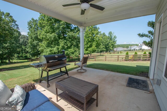 view of patio with a grill, ceiling fan, and an outdoor living space