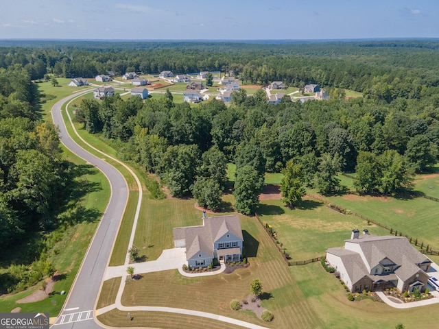 drone / aerial view featuring a view of trees