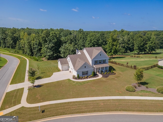 birds eye view of property with a wooded view