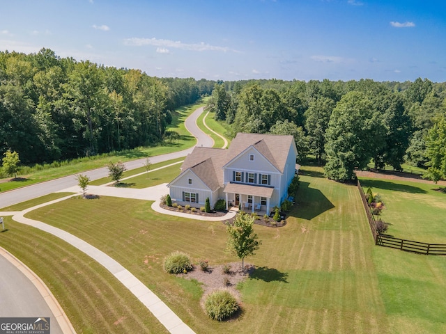 aerial view featuring a wooded view