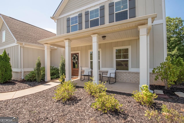 view of exterior entry with a porch