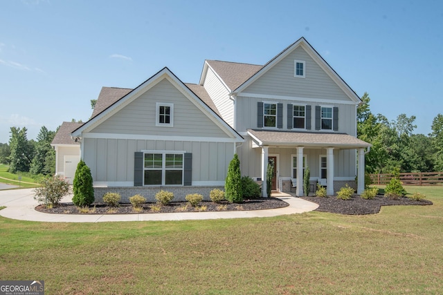 view of property with a front lawn and covered porch