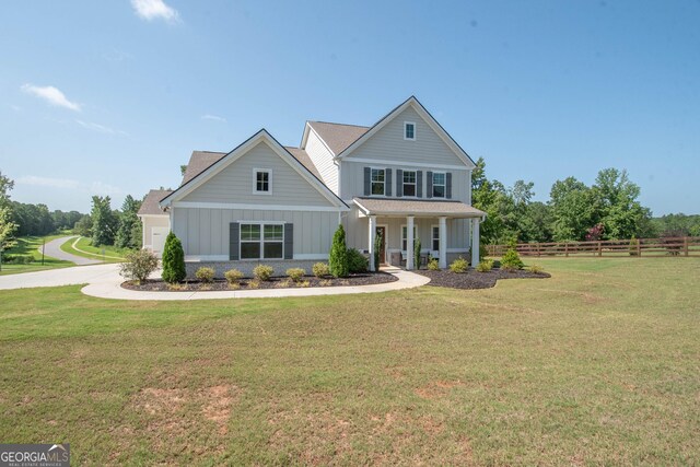 view of front of house with covered porch and a front yard