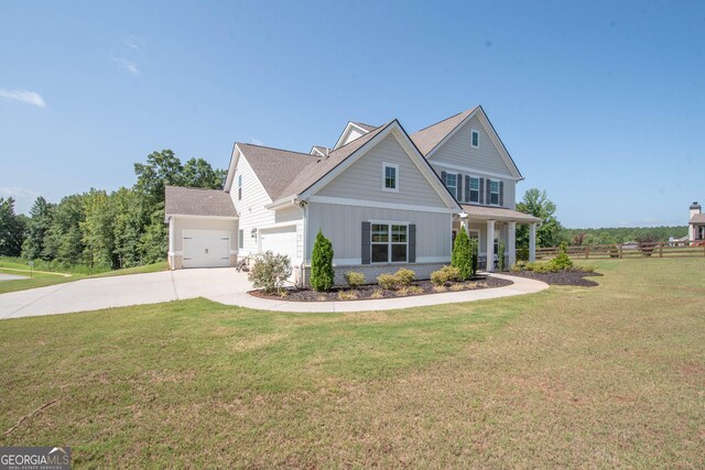 view of front of home with a garage and a front lawn