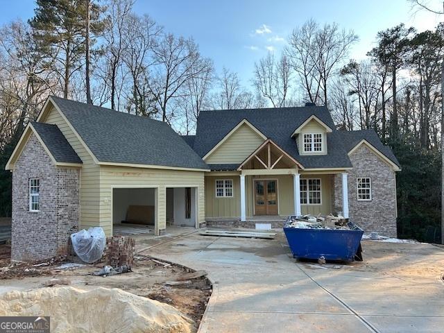 view of front of home with a garage and french doors