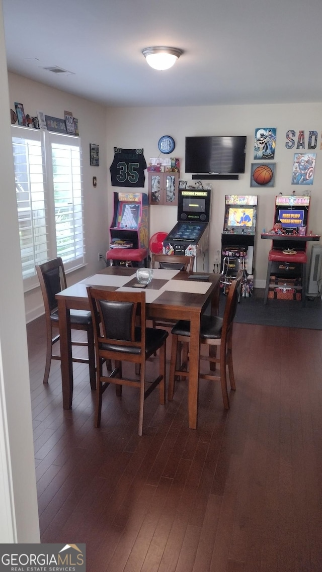 dining space featuring dark hardwood / wood-style flooring