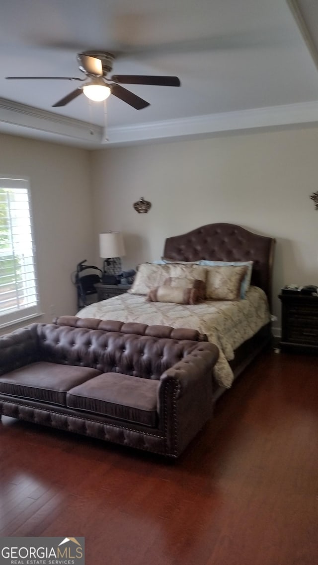 bedroom with ceiling fan, ornamental molding, and dark hardwood / wood-style floors