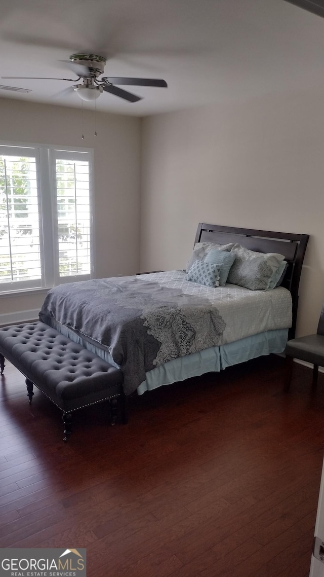 bedroom with dark wood-type flooring and ceiling fan