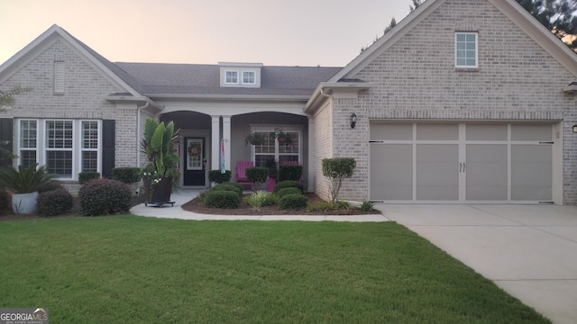 view of front of property featuring a garage and a yard