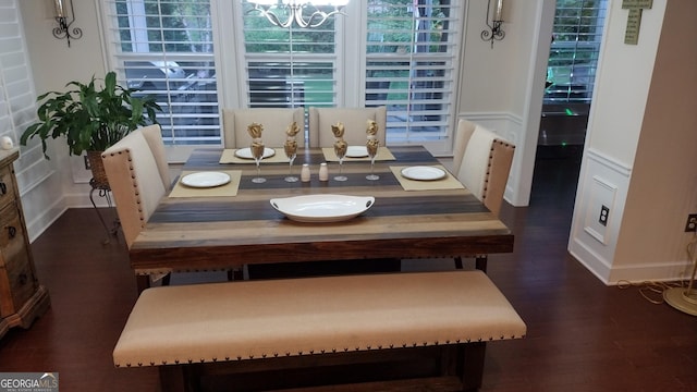 dining room featuring dark hardwood / wood-style flooring and a chandelier