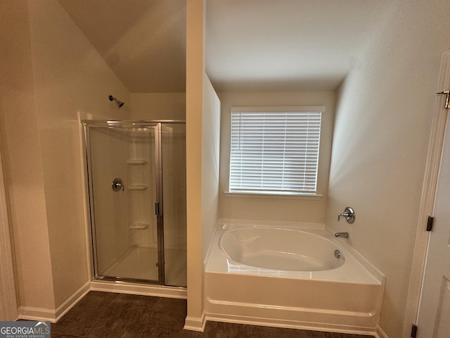 bathroom with independent shower and bath and lofted ceiling