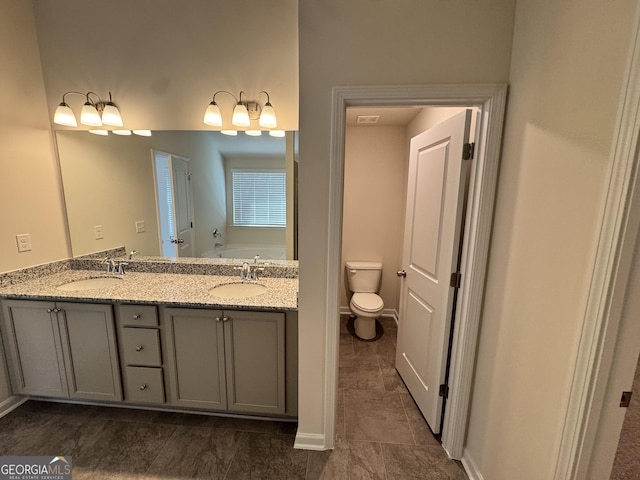 bathroom featuring a bathtub, vanity, and toilet