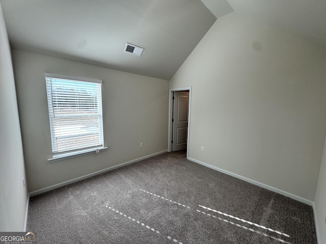 unfurnished bedroom with carpet flooring and lofted ceiling