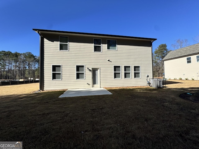 back of house with a lawn and a patio area