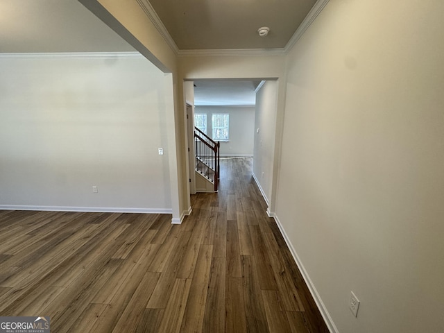 corridor with dark wood-type flooring and ornamental molding