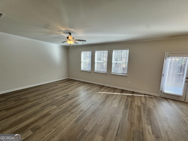 spare room featuring a wealth of natural light, ceiling fan, hardwood / wood-style floors, and ornamental molding