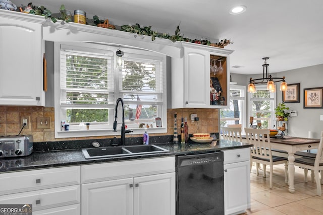 kitchen featuring decorative backsplash, white cabinetry, dishwasher, and sink