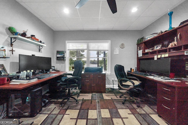 office area with a paneled ceiling, light hardwood / wood-style flooring, and ceiling fan