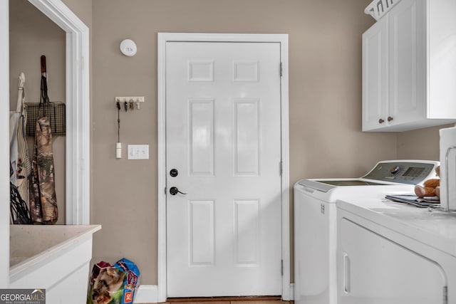 laundry area with cabinets and washing machine and dryer