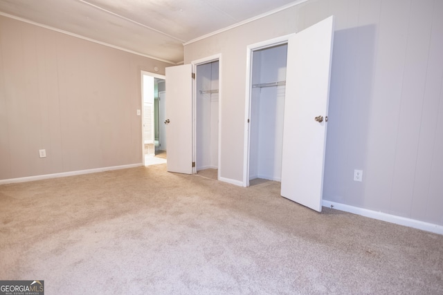 unfurnished bedroom featuring light carpet and ornamental molding