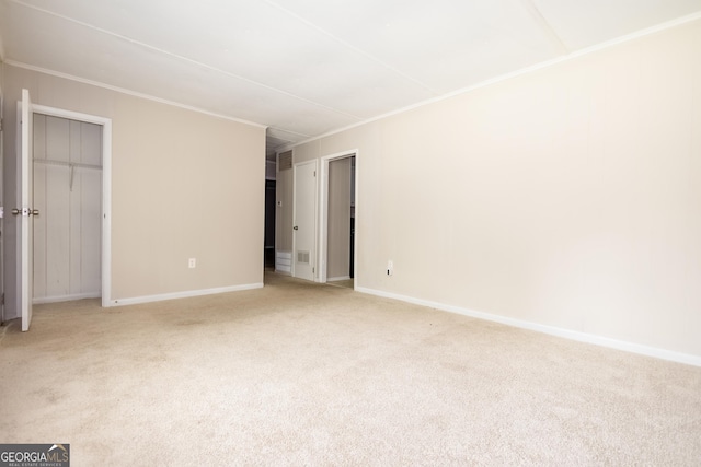 unfurnished bedroom with crown molding and light colored carpet