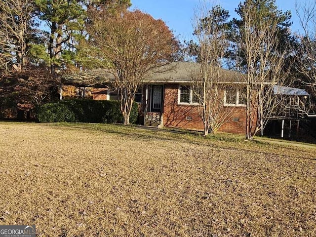 rear view of property featuring a lawn