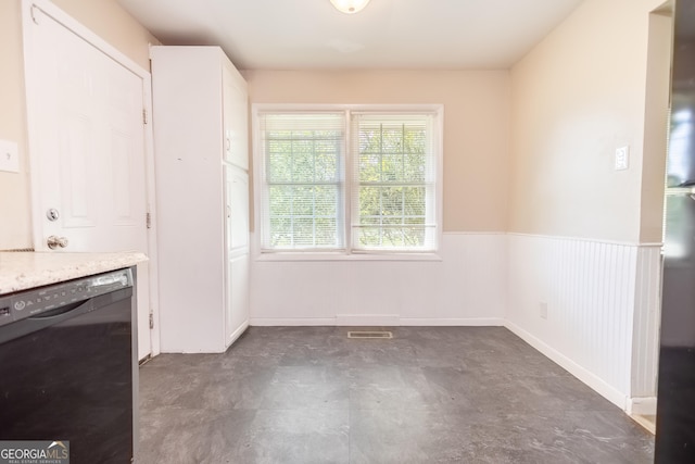 kitchen featuring dishwasher and white cabinets