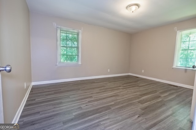 empty room featuring dark hardwood / wood-style flooring