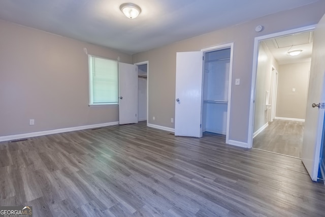 unfurnished bedroom with hardwood / wood-style floors