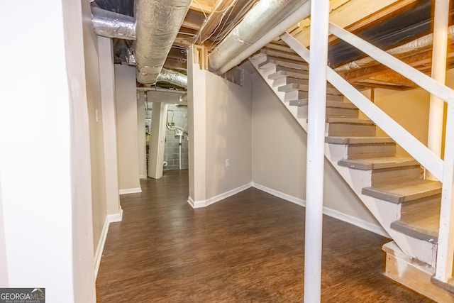 basement with dark hardwood / wood-style floors