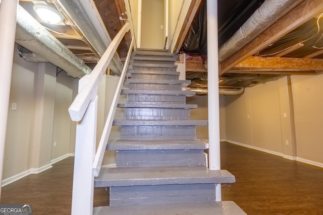 stairway with hardwood / wood-style floors