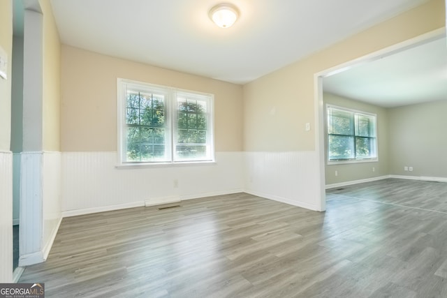 unfurnished room with wood-type flooring