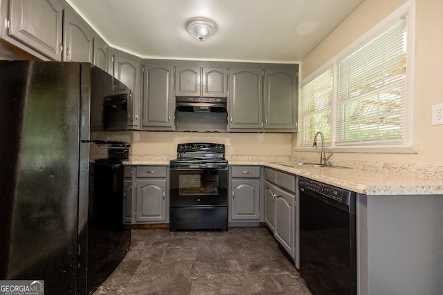 kitchen featuring sink, gray cabinetry, and black appliances