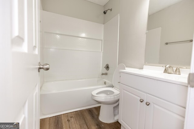 full bathroom featuring hardwood / wood-style flooring,  shower combination, toilet, and vanity