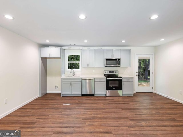 kitchen featuring appliances with stainless steel finishes, sink, and hardwood / wood-style floors