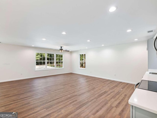 unfurnished living room featuring ceiling fan and light hardwood / wood-style flooring