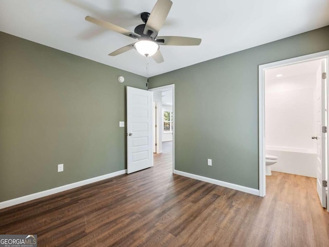 unfurnished bedroom with ceiling fan, connected bathroom, and hardwood / wood-style flooring