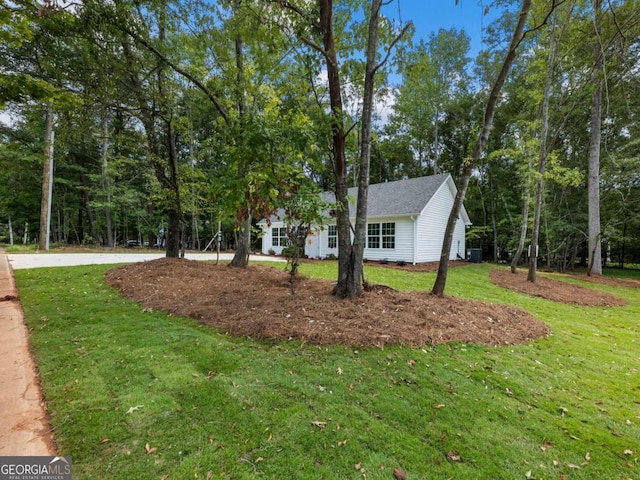 view of side of property with a yard