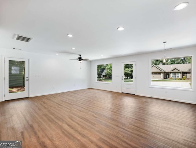 unfurnished living room featuring hardwood / wood-style floors and ceiling fan