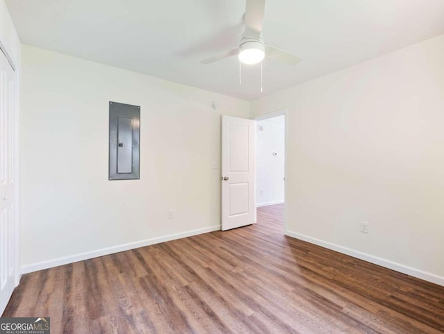 unfurnished room featuring ceiling fan, wood-type flooring, and electric panel