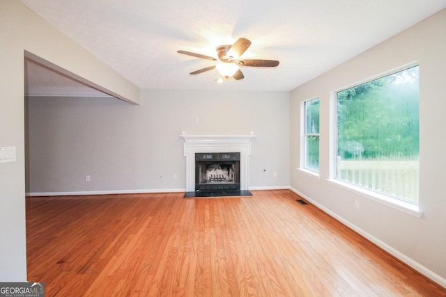 unfurnished living room featuring light hardwood / wood-style floors and ceiling fan