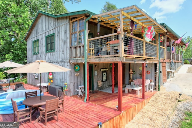 rear view of property featuring a deck