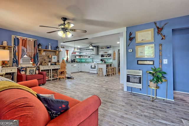 living room featuring hardwood / wood-style flooring and ceiling fan