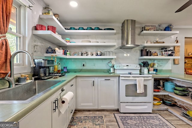 kitchen featuring white electric range, white cabinets, light wood-type flooring, wall chimney exhaust hood, and sink