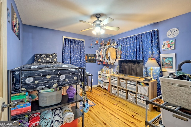 bedroom with light hardwood / wood-style flooring and ceiling fan