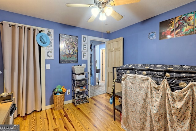 bedroom with light hardwood / wood-style floors and ceiling fan