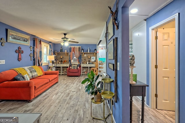 living room featuring light hardwood / wood-style flooring and ceiling fan