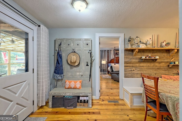 interior space with light wood-type flooring and a textured ceiling