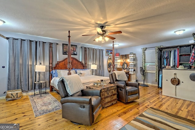 bedroom featuring light wood-type flooring and a textured ceiling